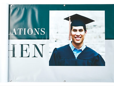 Graduate in cap and gown on banner
